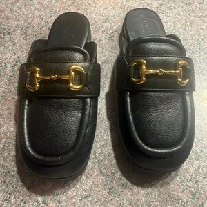 Gucci Black Leather Mules with Gold Bit Detail